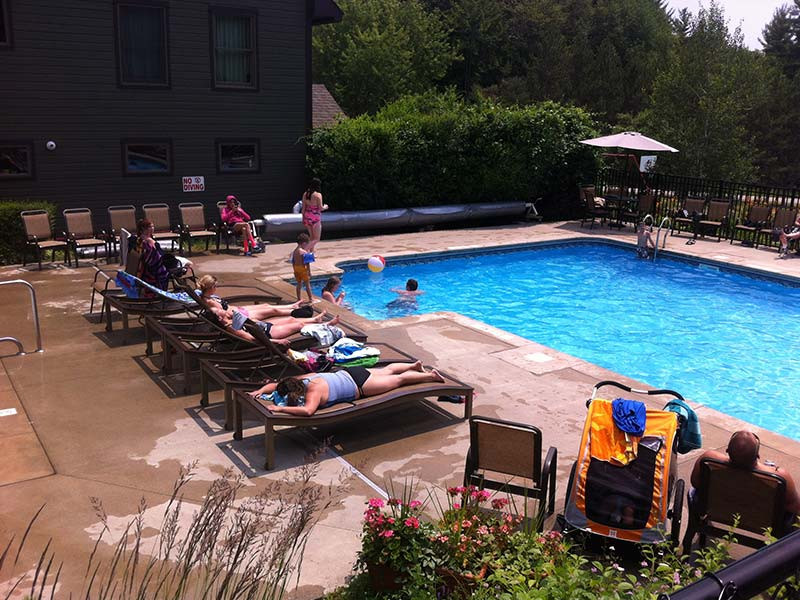 People sunbathing poolside